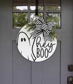 a door hanger with a black and white bow on it