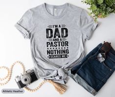 I'm A Dad And Pastor Nothing Scares Me Shirt, Pastor Dad Shirt, Gift For Pastor, Pastor Appreciation Shirt, Church Leader Shirt, Pastor Tee ✅ Contact us if you need: Any other color / Specific Size / Back Print / Different design or Customisation..   Ordering Process for our valued customers ~ Please follow all steps to place an order. ~ Please select the shirt color and size. ~ Please select color of the shirt from drop down options. ~ If you want to purchase more than 1 , add current item to y Gift For Pastor, Pastor Appreciation, Pastors Appreciation, Baggy Sweaters, Gifts For Pastors, Medical Humor, I Am Scared, Dad To Be Shirts, Black Print