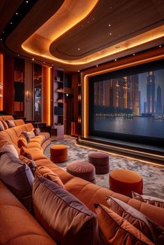 a home theater with orange couches and large screen