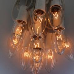 a bunch of light bulbs that are on a wall with some wires attached to them