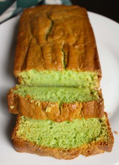 a loaf of green cake sitting on top of a white plate