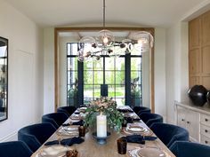 a dining room table is set with plates and place settings