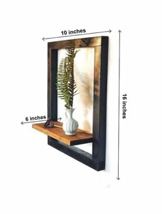 a wall mounted shelf with a potted plant in it and measurements for the height