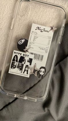 a plastic case with some stickers on it and a ticket for hype boy