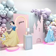 there are some princess figurines in front of a castle with balloons on the walls