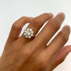 a woman's hand with a diamond ring on it