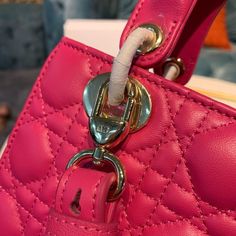 CHRSTN DR Small Lady DYOR Bag Gold toned hardware Hot Pink For Women 8in/20cm CD Rep 1:1 Measurements: 20 x 16.5 x 9 cm / 8 x 6.5 x 3.5 inches The Lady DYOR handbag epitomizes the House’s vision of elegance and beauty. Refined and sleek, the timeless creation is crafted in blush and covered with Cannage stitching, creating an instantly recognizable quilted texture. The pale gold-finish metal ‘D.I.O.R.’ charms embellish and illuminate its silhouette. Featuring a removable chain shoulder strap, th Lady Dior Handbag, Louis Vuitton Shirt, Chanel Shirt, Small Lady, Dior Handbags, Luxury Products, Pale Gold, Evening Clutch Bag, The Lady