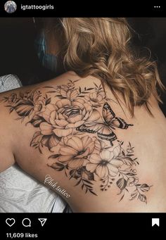 a woman's back with flowers and a butterfly on it