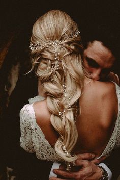 the back of a bride's head as she hugs her groom