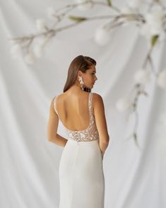 a woman in a white dress looking back