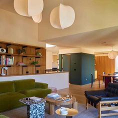 a living room filled with furniture and lots of bookshelves on top of it