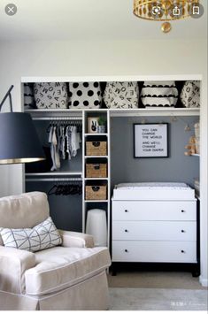 a baby's nursery closet with white furniture and black and white accessories on shelves