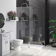 a white toilet sitting next to a shower in a bathroom with black walls and floors