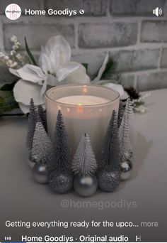 a candle sitting on top of a table next to christmas decorations