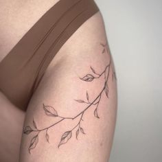 a woman's thigh with leaves on it