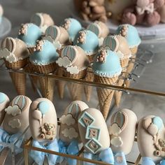 some ice cream cones and cupcakes are on display