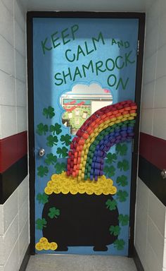 a door decorated to look like a pot with a rainbow and shamrocks on it