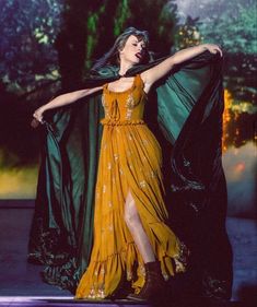 a woman in a yellow dress is dancing