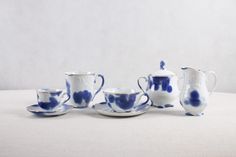 blue and white porcelain tea set with matching saucers