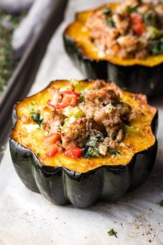 three stuffed acorns with meat and vegetables in them