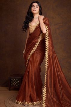 Enhance your ethnic charm by wearing this dark brown net saree which will make you ready to make a statement on the upcoming occassion.This u neck and sleeveless blouse accentuated with resham thread and sequins work.It is matched with net lightweight saree in dark brown color designed with stone and lace work.This saree blouse can be customized up to the maximum size available in inches 58 around the bust. Slight color variation may occur due to photographic reasons. Dark Saree, Brown Net Saree, Dark Brown Saree, Rust Saree, Organza Silk Saree, Net Saree, Dark Brown Color, Saree Blouse, Sleeveless Blouse