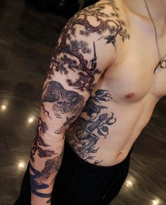 a man with tattoos on his arm and chest