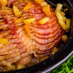 ham and pineapples are cooked in the crockpot with onions, carrots, and celery