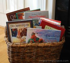 a basket filled with books sitting on top of a hard wood floor