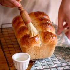 a loaf of bread being brushed with a brush