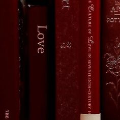 a row of red books with white writing on them