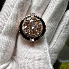 a diamond ring sitting on top of a white glove