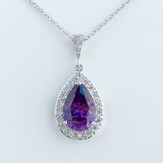 Luxury purple amethyst cubic zirconia bridal tear drop dangle pendant and necklace in rhodium plated brass setting. Necklace pendant features a large teardrop with pear cut purple ametyst cubic zirconia center surrounded by tiny round zirconia crystals. and dangles from cubic zirconia bail. Length of the rhodium plated chain is 18 inches and comes with 2 inches extender and lobster clasp. For matching earrings click: https://www.etsy.com/listing/398372301/purple-amethyst-wedding-crystal-earrings Formal Amethyst Drop Necklace, Formal Drop Amethyst Necklaces, Formal Drop Amethyst Necklace, Teardrop Amethyst Necklace For Formal Occasions, Sparkling Drop Bridal Necklace, Formal Teardrop Amethyst Necklace, Teardrop Cubic Zirconia Pendant Necklace For Gift, Cubic Zirconia Bridal Necklace With Teardrop Pendant, Teardrop Gemstone Necklace For Wedding