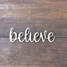 the word believe is cut out from wood