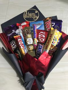 a bouquet of chocolates and candy wrapped in paper