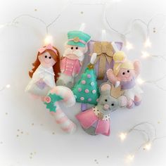 a group of stuffed animals sitting next to each other on a white surface with christmas lights