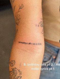 a woman's arm with tattoos and words on it