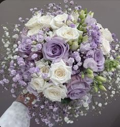 a bridal bouquet with purple and white flowers