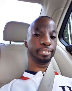 a man sitting in the back seat of a car