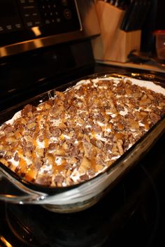 a casserole dish sitting on top of an oven in front of the stove