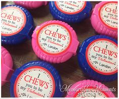 some pink and blue candy cups with labels on them