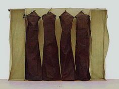 five brown dresses are lined up in front of a white wall and the bottom one is open