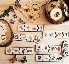 a wooden table topped with lots of different types of magnets and paper cut outs