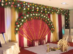 a room decorated with flowers and white linens for a wedding or special event venue