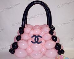 a chanel bag made out of pink and black balloons with the logo on it