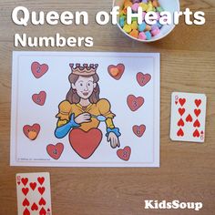 the queen of hearts card game is next to some candy