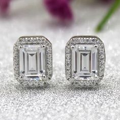 Emerald Cut Moissanite Stud Engagement Earrings 14K White Gold Handmade Minimalist GRA Certified VVS Diamond Classic Women Earrings For Gift ➤ 𝐓𝐲𝐩𝐞: 𝐌𝐨𝐢𝐬𝐬𝐚𝐧𝐢𝐭𝐞 𝐃𝐢𝐚𝐦𝐨𝐧𝐝 ➤ 𝐂𝐚𝐫𝐚𝐭 𝐰𝐞𝐢𝐠𝐡𝐭:- 2.40 Tcw ➤ 𝐃𝐢𝐚𝐦𝐨𝐧𝐝 𝐒𝐡𝐚𝐩𝐞:- Round & Emerald ➤ 𝐃𝐢𝐚𝐦𝐨𝐧𝐝 𝐂𝐨𝐥𝐨𝐫: DEF ➤ 𝐂𝐥𝐚𝐫𝐢𝐭𝐲: VVS ➤ 𝐏𝐨𝐥𝐢𝐬𝐡: Excellent  ➤ 𝐒𝐲𝐦𝐦𝐞𝐭𝐫𝐲: Excellent ➤ 𝐇𝐚𝐫𝐝𝐧𝐞𝐬𝐬: 9/10 ➤ 𝐃𝐢𝐚𝐦𝐨𝐧𝐝 𝐓𝐞𝐬𝐭𝐞𝐫 𝐏𝐚𝐬𝐬 : Yes ➤ 𝐌𝐞𝐭𝐚𝐥 𝐓𝐲𝐩𝐞: 925 Silver/10K/14K/18K Gold ➤ 𝐌𝐞𝐭𝐚𝐥 𝐖𝐞𝐢𝐠𝐡𝐭: 4.50 To 7.32 Grams 𝐂𝐮𝐬𝐭𝐨𝐦𝐢𝐳𝐚𝐭𝐢𝐨𝐧 𝐒𝐞𝐫𝐯𝐢𝐜𝐞𝐬 ➺ I'm glad to make custom jewelry using this diamond within 5-7 business working days. please feel free to contact me for more. ➺ If you have your Special Requirement or Customized Bulk Orders or wanted an Types Of Diamond Cuts, Minimal Earrings Studs, Engagement Earrings, Vvs Diamond, Halo Stud Earrings, Minimalist Earrings Studs, Emerald Cut Moissanite, Simple Stud Earrings, Womens Earrings Studs