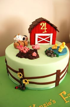 a cake decorated with farm animals and a barn