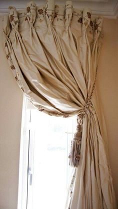 the curtains are hanging on the window sill