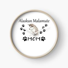 a clock with an image of a dog's paw prints on it and the words alaska malamute mom