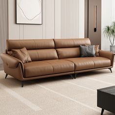 a brown leather couch sitting in a living room